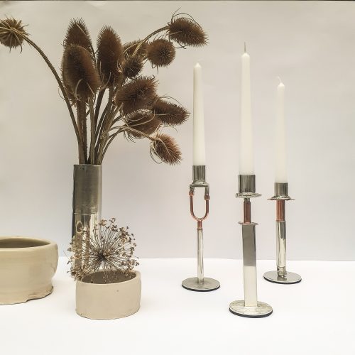 Candlesticks and vase on white background